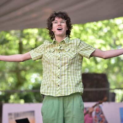 Foto van persoon die met de armen wijd staat.