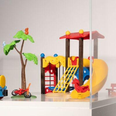 Kinderspeelgoed dat bestaat uit een trein, boom, klimrek en glijbaan.